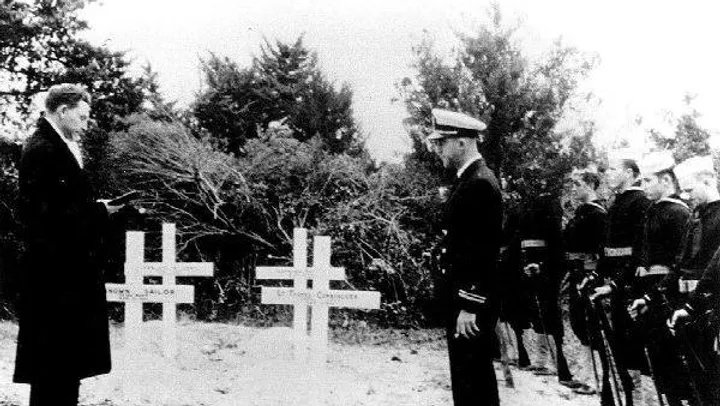 British Cemetery Commemoration Black and white image of sailors commemorating gravestones in Ocracoke.