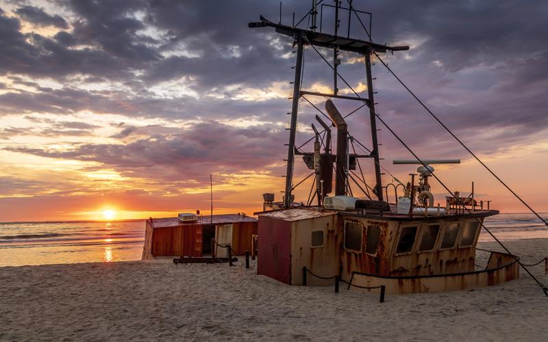 Old ship washed up on shore and buried in sand at the graveyard of the Atlantic