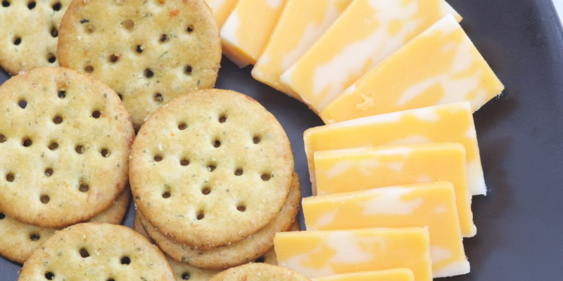 Beach Snacks - Crackers and Cheese Plate with round crackers and white and yellow Colby cheese.