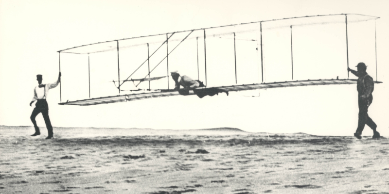 The Wright Brothers flying an airplane on the Outer Banks.