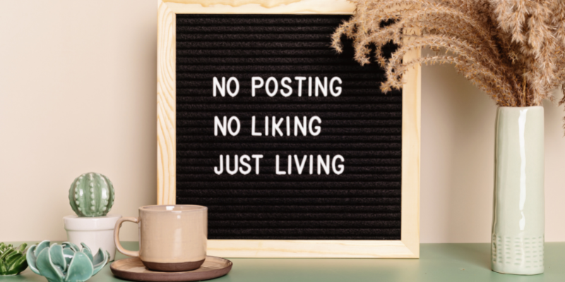 Unplug Black felt sign that reads "No links, no posting, just living."