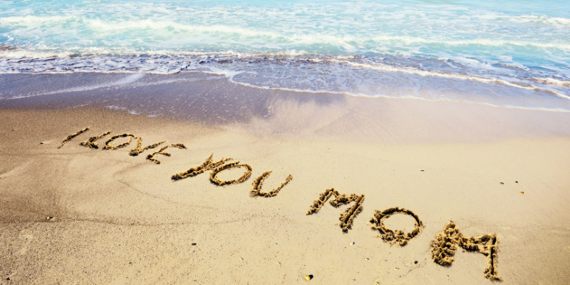 Celebrate Mom at the Outer Banks for Mother's Day! "I love you mom" written in the sand on the beach