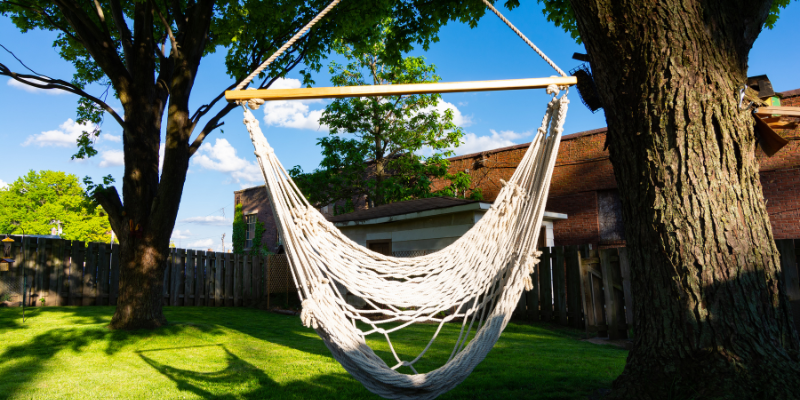 Get a Hammock Swing from Nags Head Hammocks Hammock swing in a backyard.