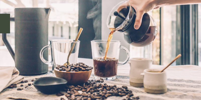 Coffee Counter Image of someone pouring coffee into mug; surrounded by coffee beans.