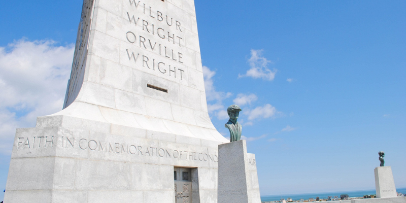 Wright Brothers Memorial Wright Brothers Memorial - Gray monument against blue sky.
