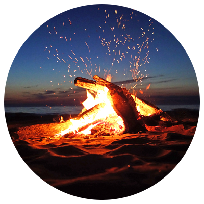 Beach campfire with bright orange flames and sparks