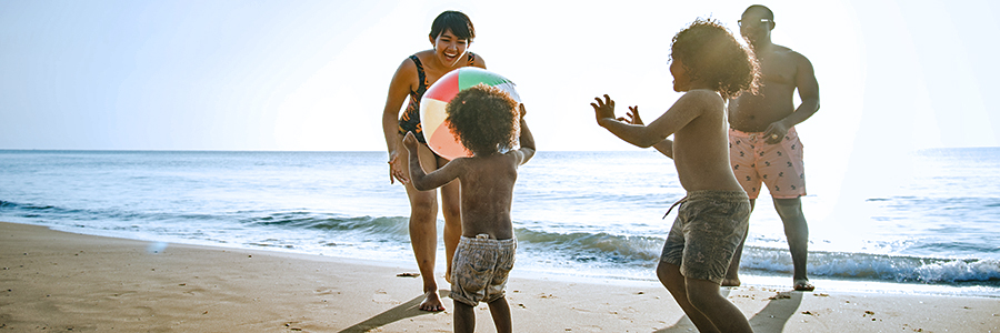 family playing on the beach