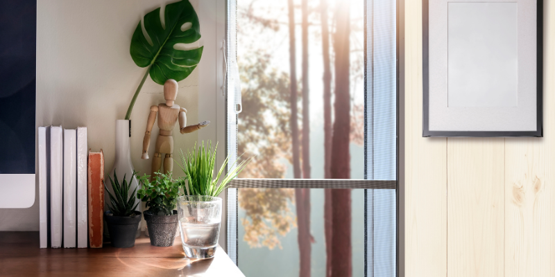 Include Lots of Natural Light and an Ocean View Office near a window with a mirror and glass of water.