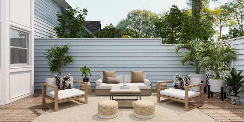 Tan, brown, and white deck furniture in front of a blue fence wall.